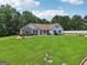Charming single-story home with a spacious lawn, stone accents, and a welcoming front porch at 1422 New Holland Cir, Mcdonough, GA 30252