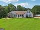 Inviting single-Gathering home featuring a well-manicured lawn and a classic design with black shutters at 1422 New Holland Cir, Mcdonough, GA 30252