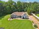 Attractive single-level home with a neatly kept lawn, stone accents, and a long driveway at 1422 New Holland Cir, Mcdonough, GA 30252