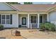 Charming front porch with decorative pillars and lush landscaping at 1422 New Holland Cir, Mcdonough, GA 30252