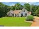 Well-kept home featuring green lawn, complemented by lush landscaping and traditional design elements at 1422 New Holland Cir, Mcdonough, GA 30252