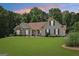 Inviting home with a well-maintained lawn and mature trees, perfect for suburban living at 1422 New Holland Cir, Mcdonough, GA 30252