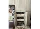 Kitchen pantry featuring organized pull-out shelving for efficient storage, next to stainless steel refrigerator at 1422 New Holland Cir, Mcdonough, GA 30252