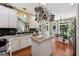 Spacious kitchen layout featuring granite countertops, an island, and wood flooring at 1422 New Holland Cir, Mcdonough, GA 30252