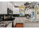 Stylish kitchen with stainless steel appliances, black backsplash, and granite countertops at 1422 New Holland Cir, Mcdonough, GA 30252