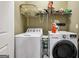 Functional laundry room with modern washer and dryer, overhead storage, and ample counter space at 1422 New Holland Cir, Mcdonough, GA 30252