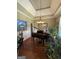Formal living room featuring hardwood floors, high ceilings, a piano, and an abundance of greenery at 1422 New Holland Cir, Mcdonough, GA 30252