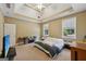 A spacious carpeted bedroom featuring a tray ceiling with fan and natural light at 1422 New Holland Cir, Mcdonough, GA 30252