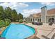 Backyard pool area with spacious concrete patio surrounded by lush trees at 1422 New Holland Cir, Mcdonough, GA 30252