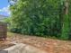A serene backyard with lush greenery and a wooded area, providing privacy and a natural setting at 3135 Journal Ct, Decatur, GA 30035