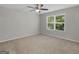 Bright bedroom featuring plush carpet, a ceiling fan, and a window with natural light at 3135 Journal Ct, Decatur, GA 30035