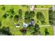 Aerial view of a lush property featuring a sparkling pool, well-manicured lawns, and mature trees, showcasing its serene setting at 135 Cherokee Pl, Fayetteville, GA 30215