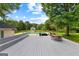 Large wooden deck with furniture overlooking a backyard with an in-ground pool at 135 Cherokee Pl, Fayetteville, GA 30215