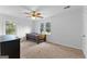 Bright bedroom with two windows, neutral carpet, and a ceiling fan at 135 Cherokee Pl, Fayetteville, GA 30215