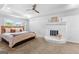 Spacious main bedroom with a tray ceiling, ceiling fan and a brick fireplace at 135 Cherokee Pl, Fayetteville, GA 30215