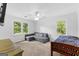 Spacious bedroom featuring a large window with backyard views and a gray sofa at 135 Cherokee Pl, Fayetteville, GA 30215