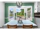 Bright dining nook with view of back deck, pool, and landscaped yard at 135 Cherokee Pl, Fayetteville, GA 30215