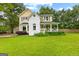 Charming two-story home with a lush front lawn and inviting front porch at 135 Cherokee Pl, Fayetteville, GA 30215