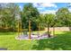 Landscaped fire pit area with stone accents, comfortable seating, and a lush green lawn perfect for outdoor gatherings at 135 Cherokee Pl, Fayetteville, GA 30215