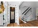 Inviting foyer with decorative wallpaper, wood floors, and a staircase at 135 Cherokee Pl, Fayetteville, GA 30215