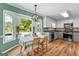 Kitchen with stainless steel appliances, gray lower cabinets, and light, airy dining nook at 135 Cherokee Pl, Fayetteville, GA 30215