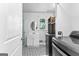 Laundry room featuring updated washer and dryer, patterned tile floor, and closet space at 135 Cherokee Pl, Fayetteville, GA 30215