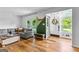 Cozy living room featuring natural light, wood floors, and comfortable seating at 135 Cherokee Pl, Fayetteville, GA 30215