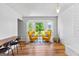 Comfortable living room with natural light, wood flooring, and white brick fireplace at 135 Cherokee Pl, Fayetteville, GA 30215