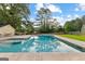 Beautiful pool view with clear blue water, surrounded by a concrete patio and lush landscaping at 135 Cherokee Pl, Fayetteville, GA 30215