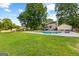 Backyard view of the in-ground pool with a large concrete deck and lounge seating at 135 Cherokee Pl, Fayetteville, GA 30215