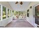 Bright sunroom featuring brick flooring, many windows, and two hanging hammock chairs at 135 Cherokee Pl, Fayetteville, GA 30215