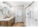 Bathroom with a double sink vanity, glass shower doors and a view to the outside at 4002 Joshua Ln, Douglasville, GA 30135