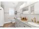Well-lit bathroom with double vanity, granite countertops, and framed mirror at 4002 Joshua Ln, Douglasville, GA 30135