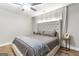 Comfortable bedroom featuring a tufted headboard, soft lighting, and hardwood flooring at 4002 Joshua Ln, Douglasville, GA 30135