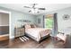 Comfortable bedroom showcasing a queen bed, neutral bedding, bedside table, and light fixture at 4002 Joshua Ln, Douglasville, GA 30135