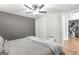 Cozy bedroom with gray accent wall, gray bedding, and view into the living area at 4002 Joshua Ln, Douglasville, GA 30135