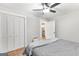 Bright bedroom with hardwood floors, ceiling fan, and closet with louvered doors at 4002 Joshua Ln, Douglasville, GA 30135