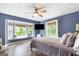 Comfortable bedroom featuring a cozy window seat, ceiling fan, and a mounted flat screen TV at 4002 Joshua Ln, Douglasville, GA 30135