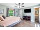 This is a comfy bedroom with a flat screen TV, ceiling fan, and view to the hall bath at 4002 Joshua Ln, Douglasville, GA 30135