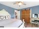 Comfortable bedroom featuring a stylish bed, barn door access to a closet, and vanity with decor at 4002 Joshua Ln, Douglasville, GA 30135