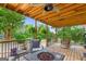 Inviting deck featuring cozy seating, a fire pit, and a scenic view of the surrounding trees at 4002 Joshua Ln, Douglasville, GA 30135