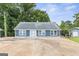 Charming blue home with well-manicured yard and spacious driveway under a clear sky at 4002 Joshua Ln, Douglasville, GA 30135