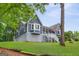 Beautiful blue home showcasing a covered porch and bay window, nestled on a green lawn at 4002 Joshua Ln, Douglasville, GA 30135