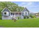 Charming blue house featuring a covered porch, bay windows, and a lush green lawn at 4002 Joshua Ln, Douglasville, GA 30135