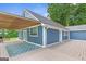 Side of blue home featuring a large, covered deck with a grill and an outdoor rug for cozy entertaining at 4002 Joshua Ln, Douglasville, GA 30135