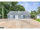 Charming blue home featuring multiple windows and a spacious driveway in a wooded setting at 4002 Joshua Ln, Douglasville, GA 30135