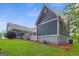 A view of the side of the blue home with a wooden deck and a well-kept lawn at 4002 Joshua Ln, Douglasville, GA 30135
