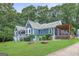 Stylish blue home with a covered porch, wooden deck, and well-maintained lawn at 4002 Joshua Ln, Douglasville, GA 30135
