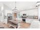 Charming kitchen features stainless appliances, granite counters, and a farmhouse dining table at 4002 Joshua Ln, Douglasville, GA 30135