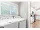 Functional laundry room with washer, dryer, and a bright window with blind at 4002 Joshua Ln, Douglasville, GA 30135